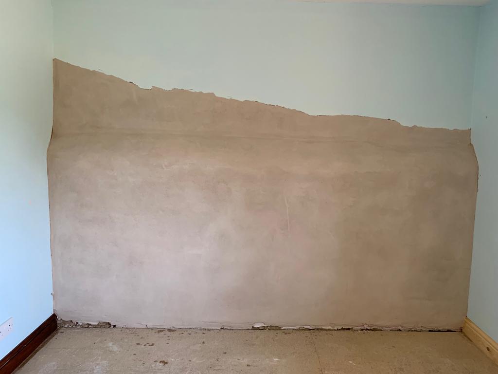 A grade II listed building wall, finished in lime plaster, by Property Conservation Services.
