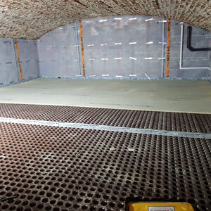 A wide view of the basement with ceiling and walls in shot, showing Delta MS500 8mm membrane in place on the basement walls and Delta MS20 floor membrane in position
