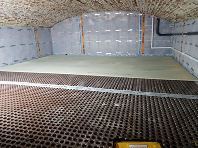 A wide view of the basement with ceiling and walls in shot, showing Delta MS500 8mm membrane in place on the basement walls and Delta MS20 floor membrane in position