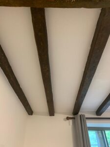 Final coat of lime and horsehair plaster between three beams