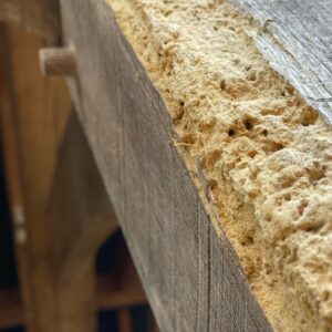 Wood worm dust, called frass, on timber