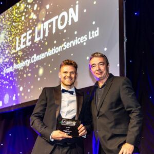 Lee Litton, damp specialist of Property Conservation Services, receiving his Property Care Apprentice of the Year Award