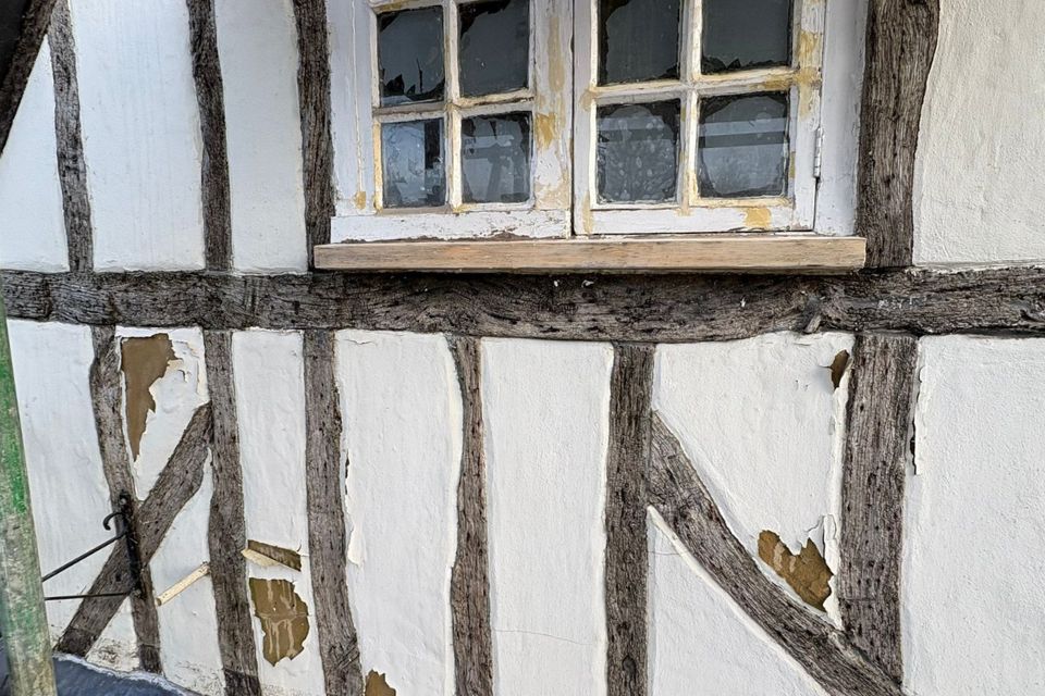 Old and damaged lime plaster on the pub's front gable