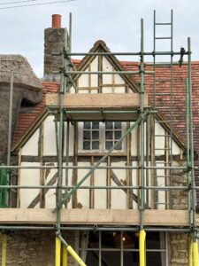 Old and damaged lime plaster on the pub's front gable - see now behind scaffolding, close up