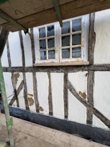 Old and damaged lime plaster on the pub's front gable