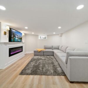 A new basement conversion with a large corner sofa and wall mounted television.