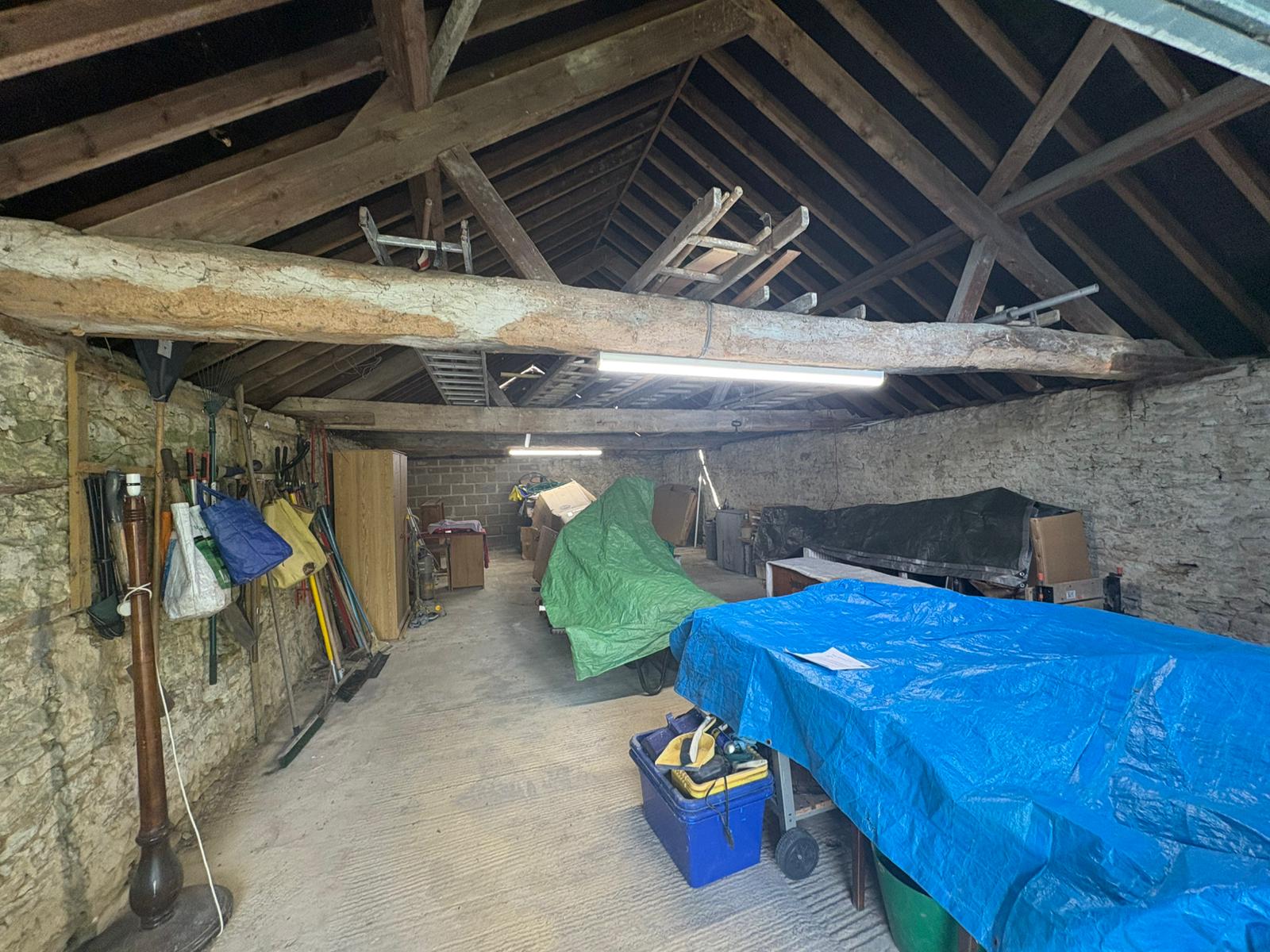 The interior of the garage, showing visible woodworm evidence on the roof timbers