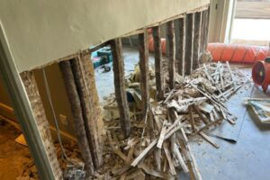 An old stud wall, stripped back to the studs alone, ready to be rebuilt and finished with lime plaster