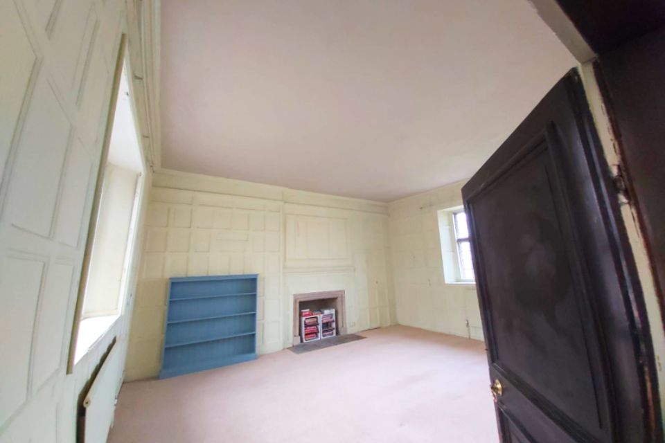 A wood-panelled room with a new lime plaster ceiling