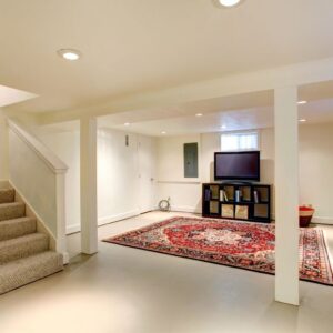 A white and cream basement with carpeted stairs and entertainment set-up